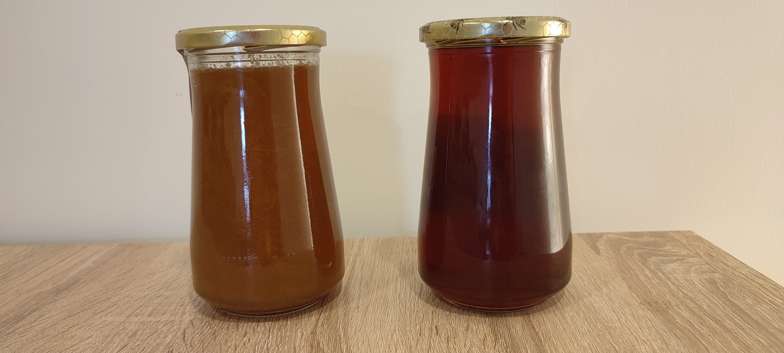 Side-by-side comparison of naturally crystallized raw mountain honey and liquid raw honey in glass jars